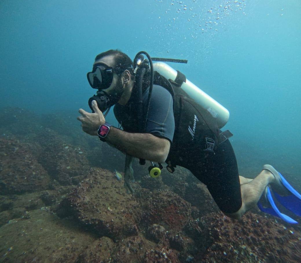 Diver Hovering Above Reef Bed