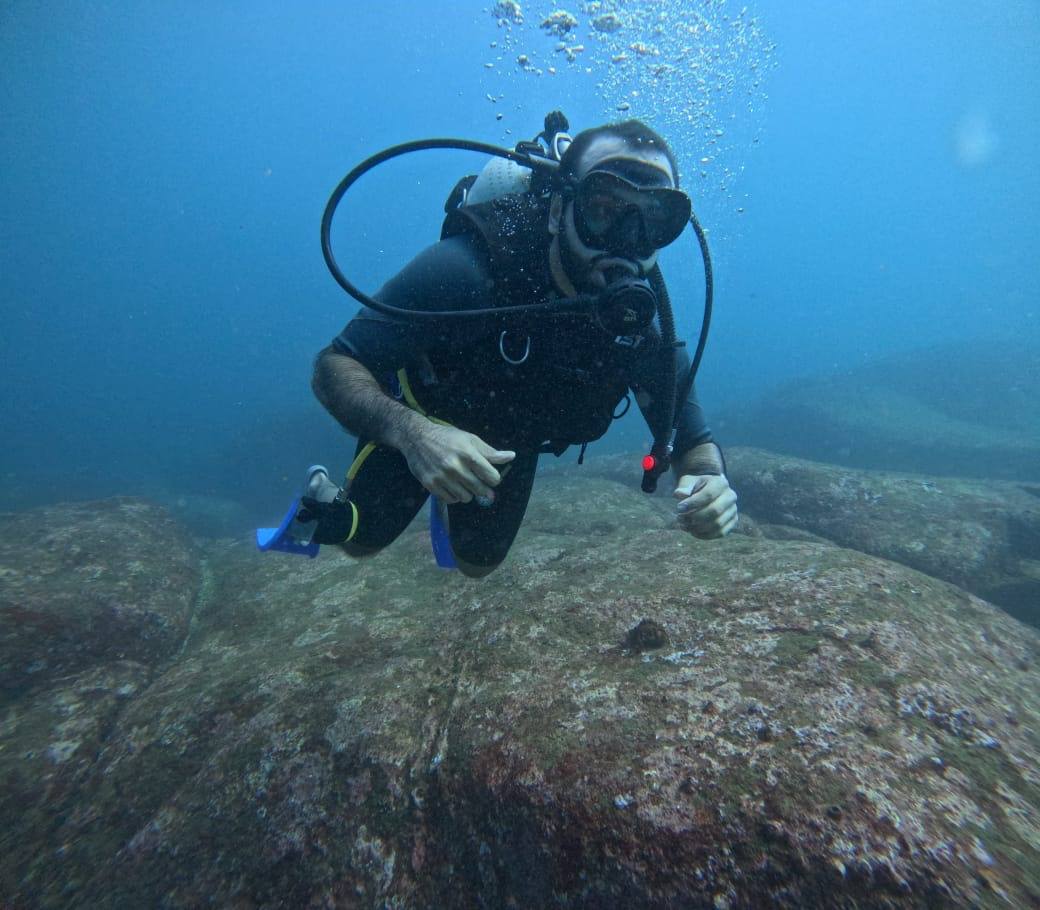 Scuba Diver Hovering in Blue Sea