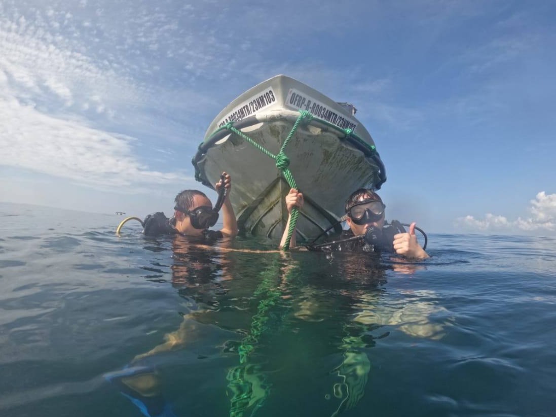 Divers at Boat Bow Rope